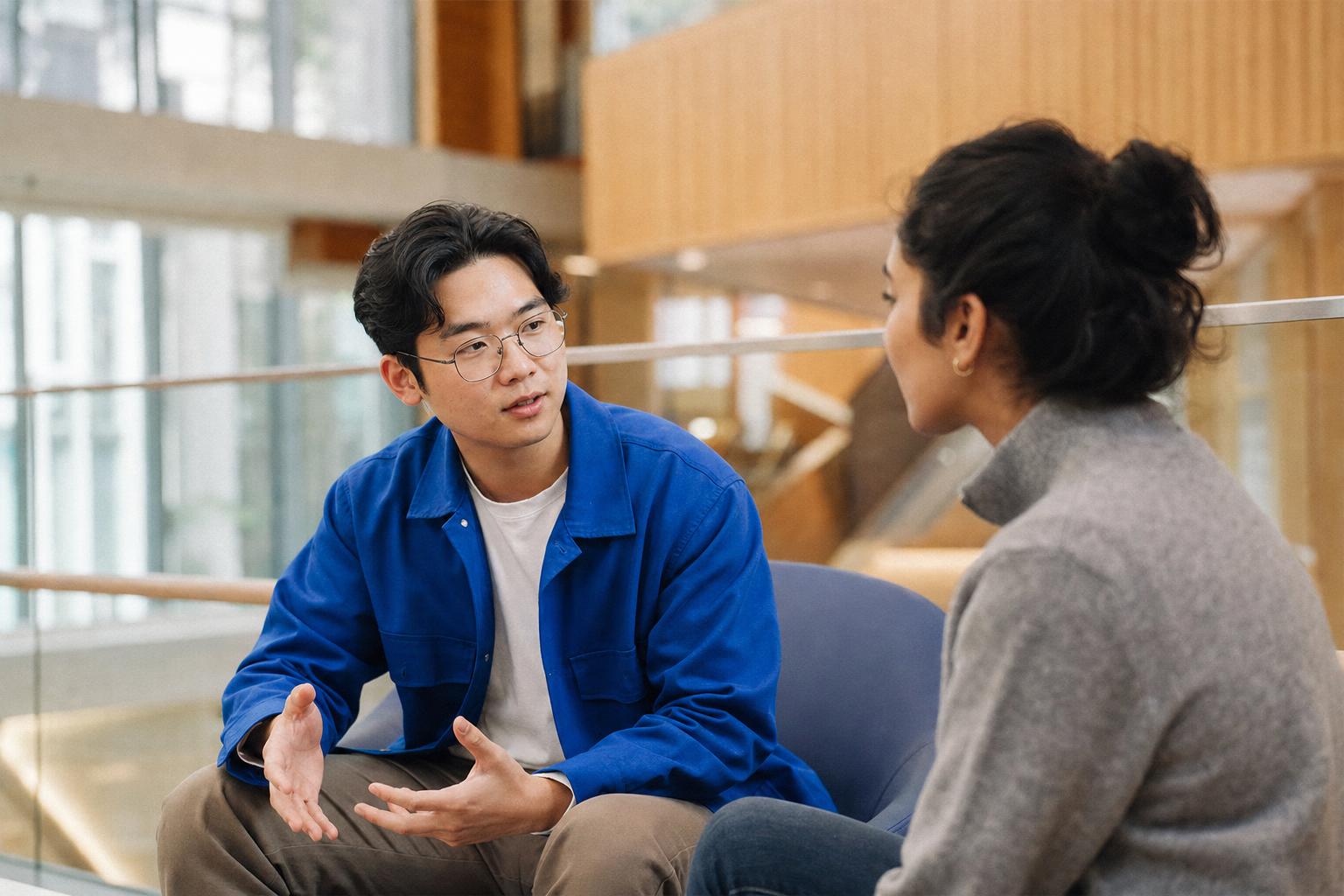 People in thoughtful conversation in a bright modern space